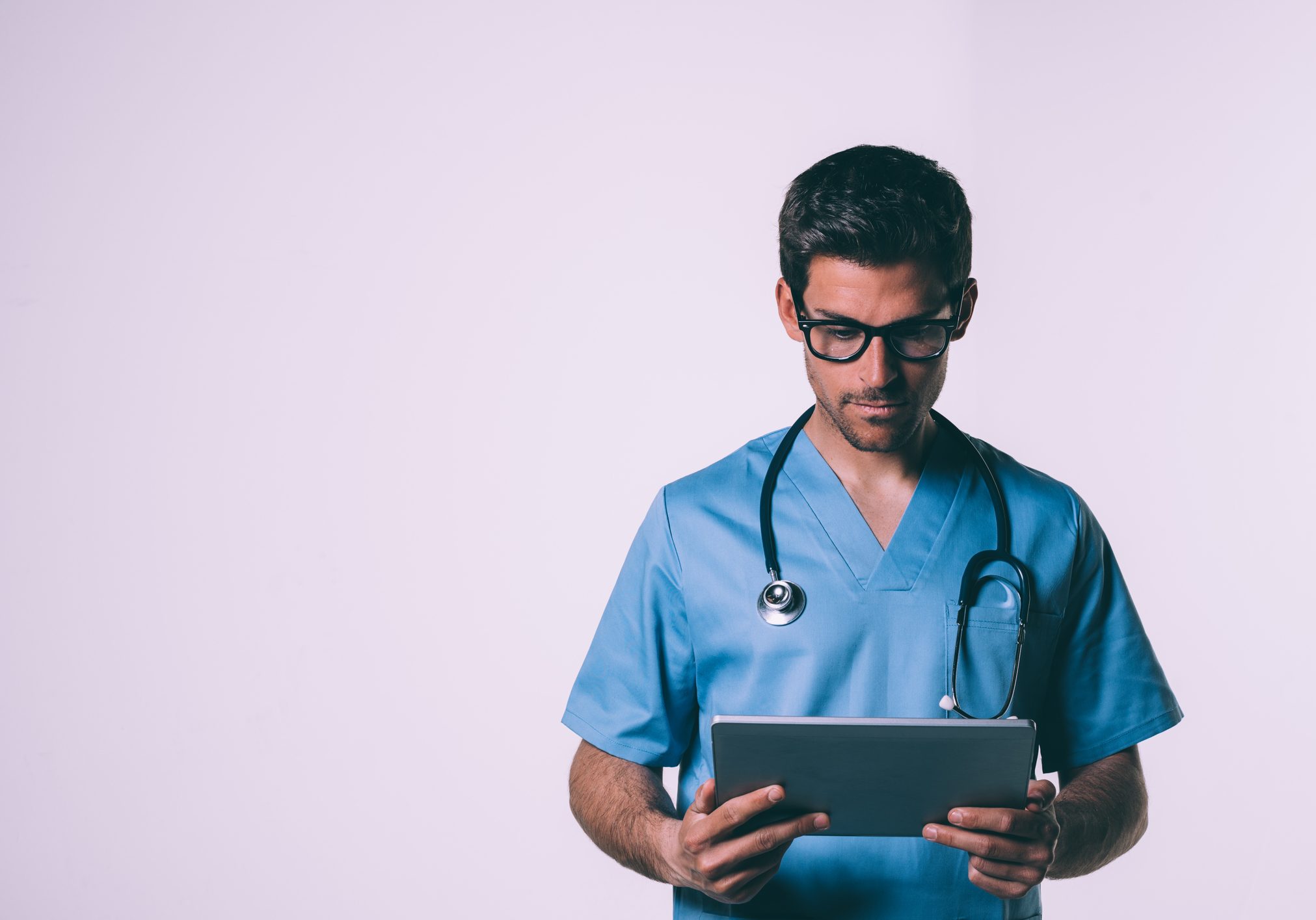 Doctor in the uniform with a tablet