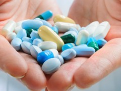 various pills in a human hand